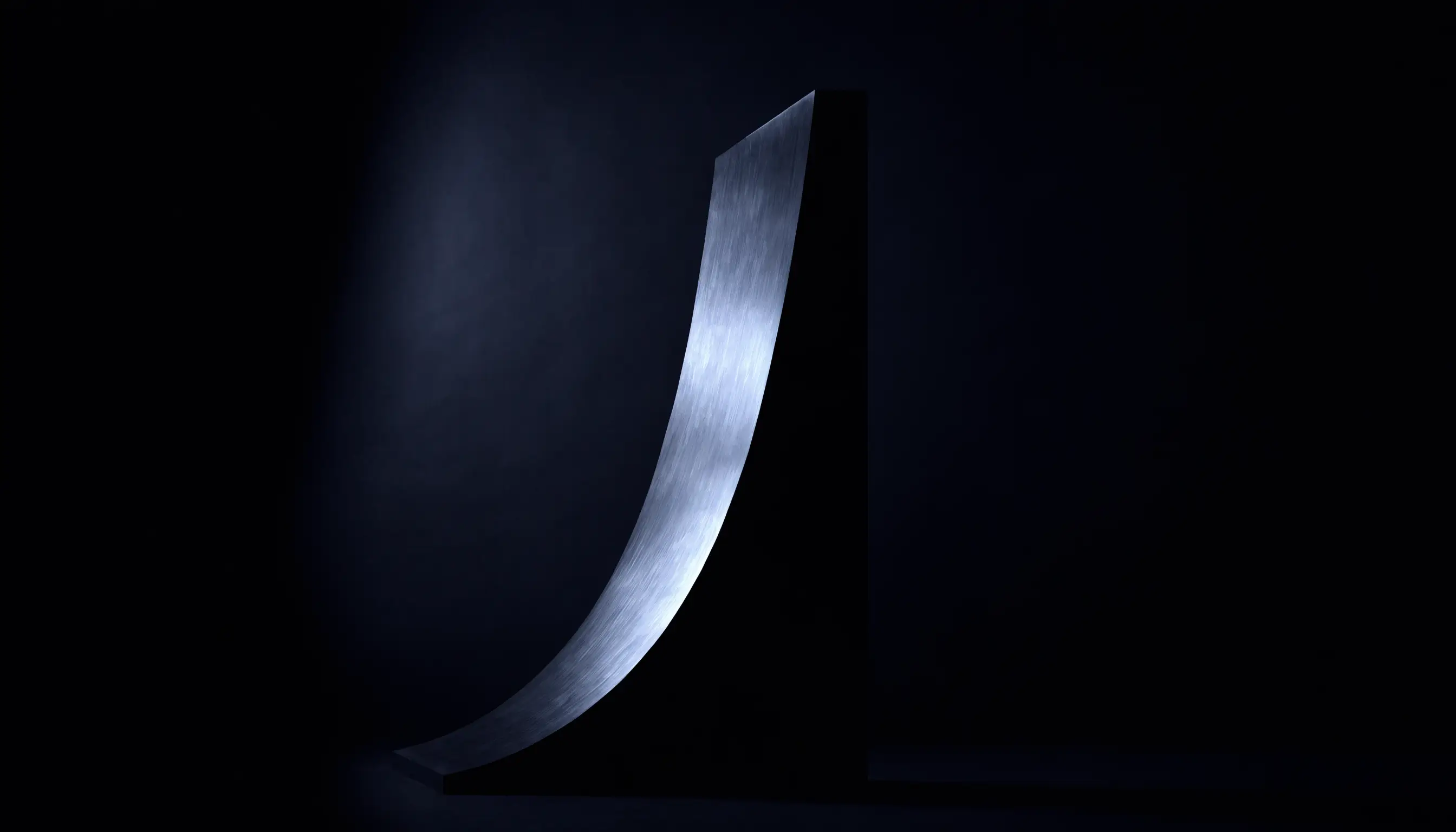 A monolithic sculptural form in near-black darkness, lit by a single sweep of cold platinum light